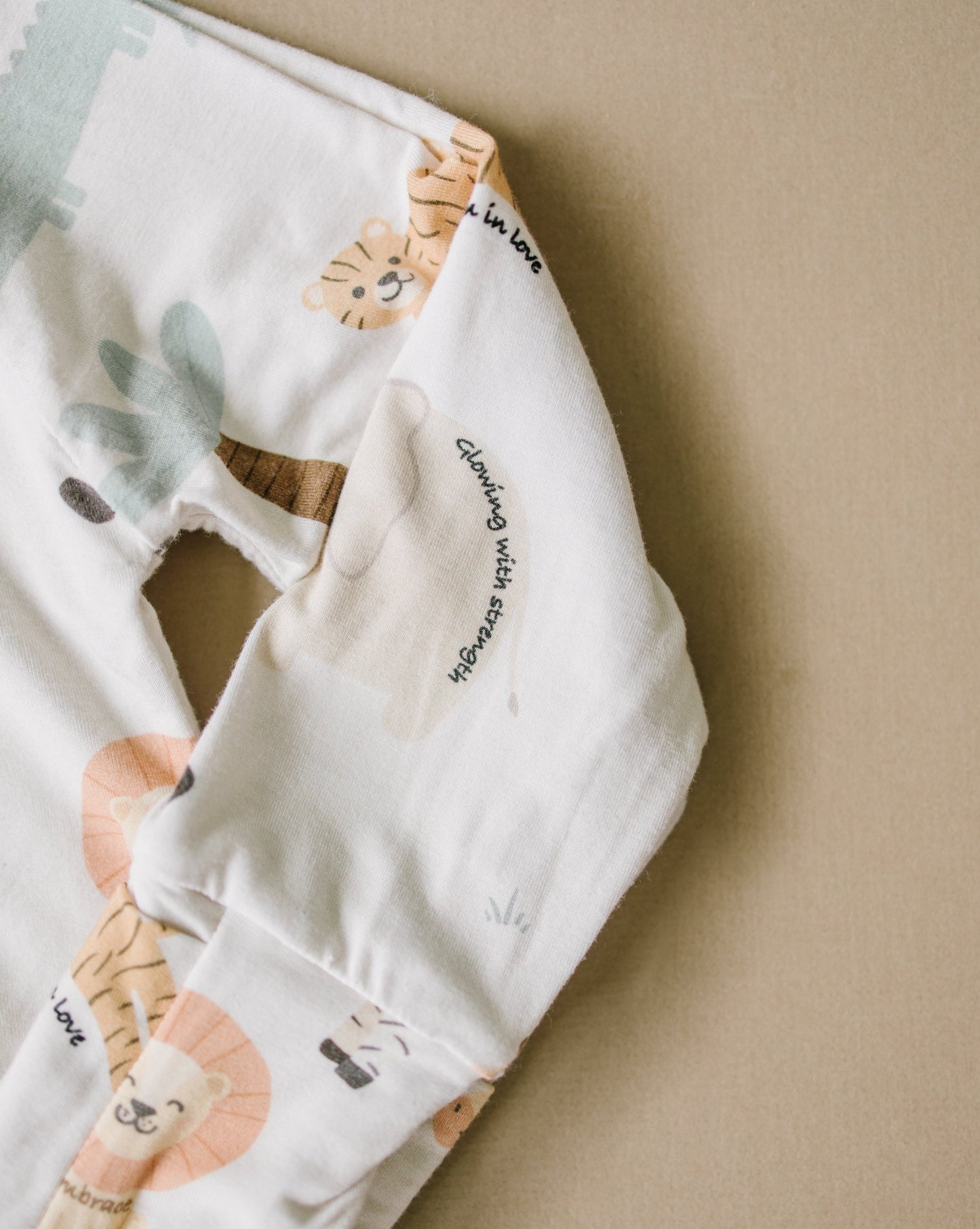 Little sleepies baby bamboo pajamas with mushroom print and words of affirmation for kids and mothers. Glowing with strength. Bloom in love.